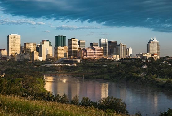 The Edmonton skyline, showing a view of skyscrapers past a wide river.