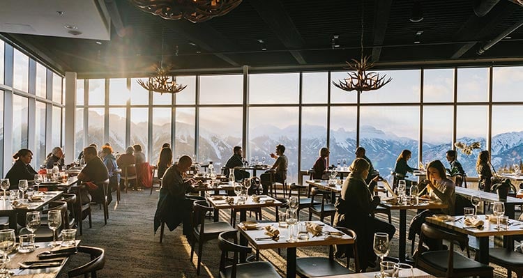The Sky Bistro dining room overlooking snowy mountain range
