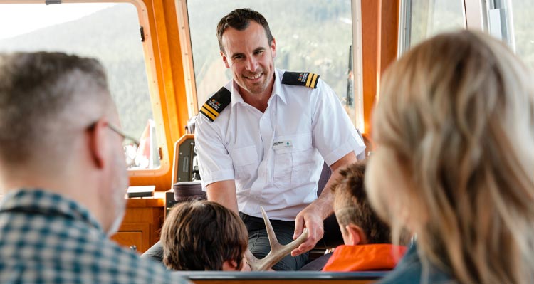 A boat captain talks to visitors.