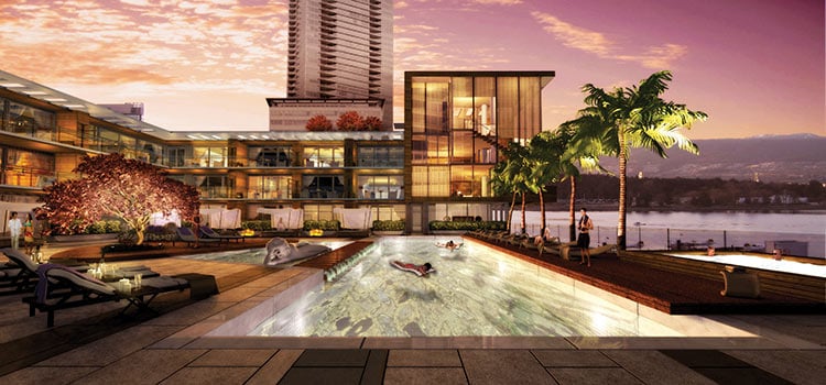 view of hotel pool at sunset with palm trees