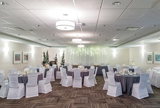 A room set up with round tables for a wedding.