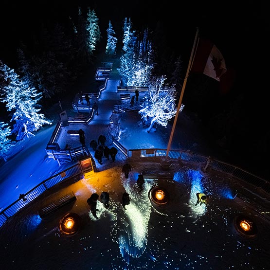 A view overlooking a lit up boardwalk.