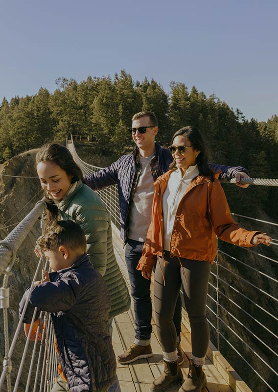 A family stands together on the Skybridge in the sun