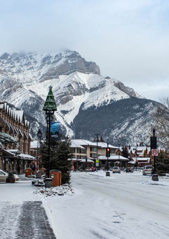 Banff Ave on a winter day with buildings covered in snow.