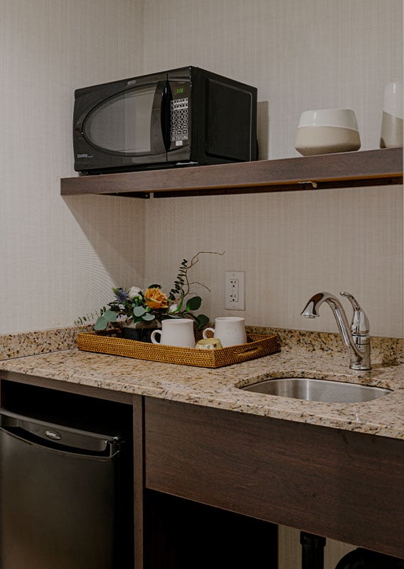 A dining tray atop a kitchen counter in a hotel suite.
