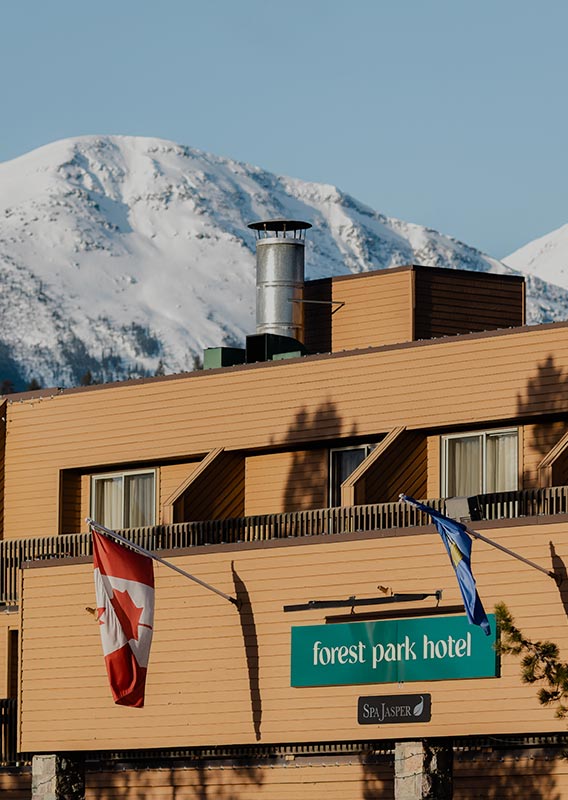 Forest Park Hotel exterior view with mountains in background