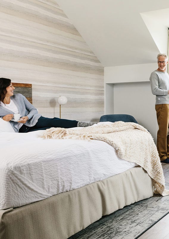 two people in a hotel room smiling at each other