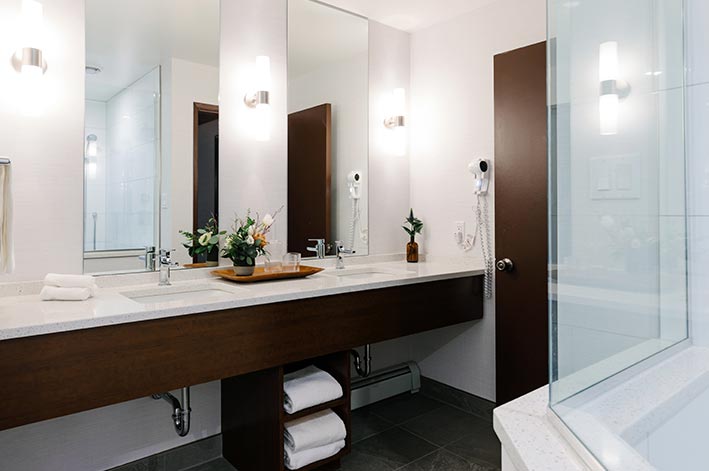 A set of bathroom sinks and mirrors.