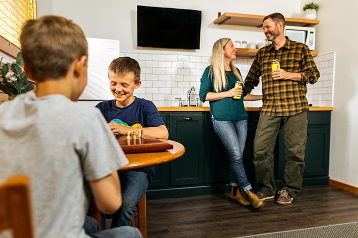 A family relaxing in a cabin kitchen