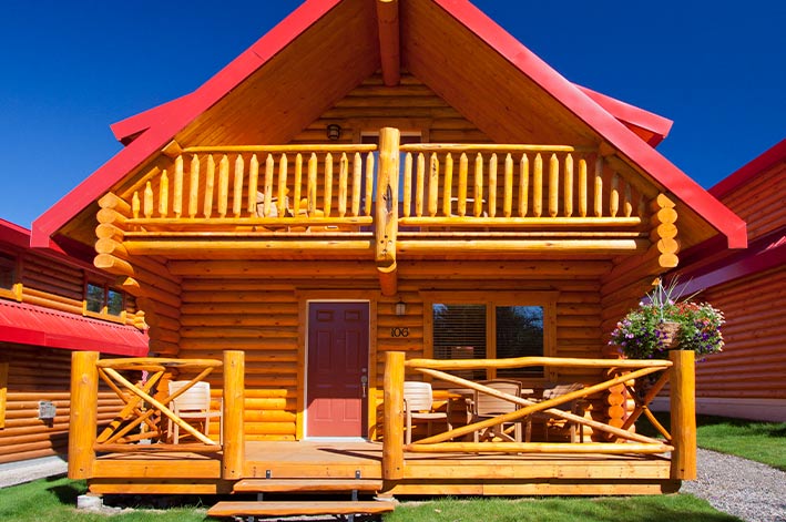A wooden cabin with a red roof