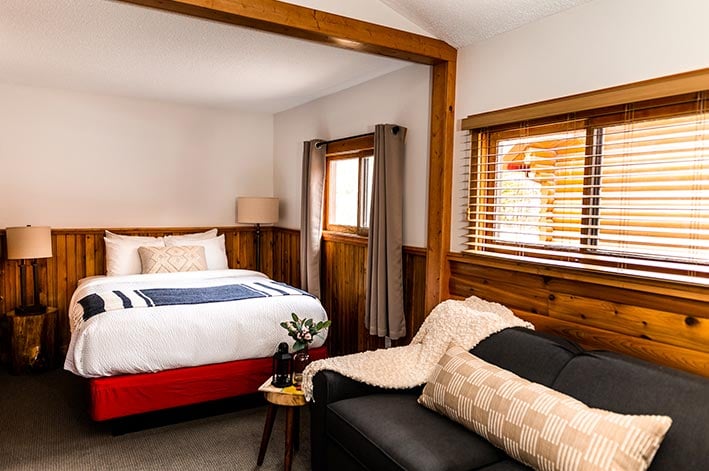 A bed in a wooden cabin