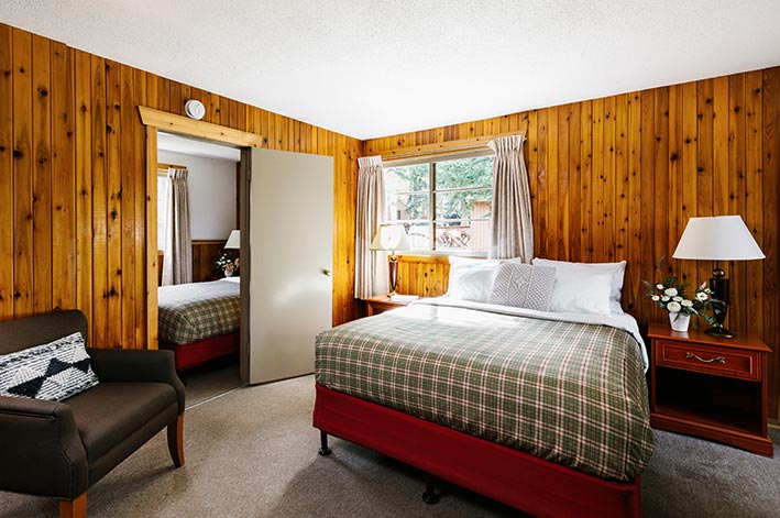 A bedroom in a wooden cabin