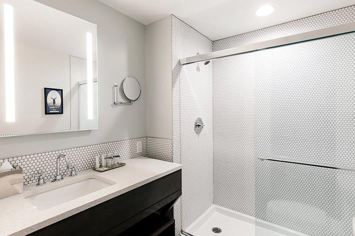 A bathroom sink and shower.