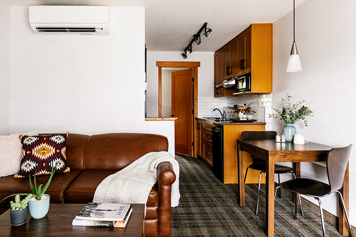 A sofa and small dining table in a hotel room