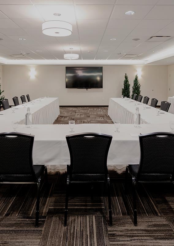 A small conference room set up with a large meeting table 
