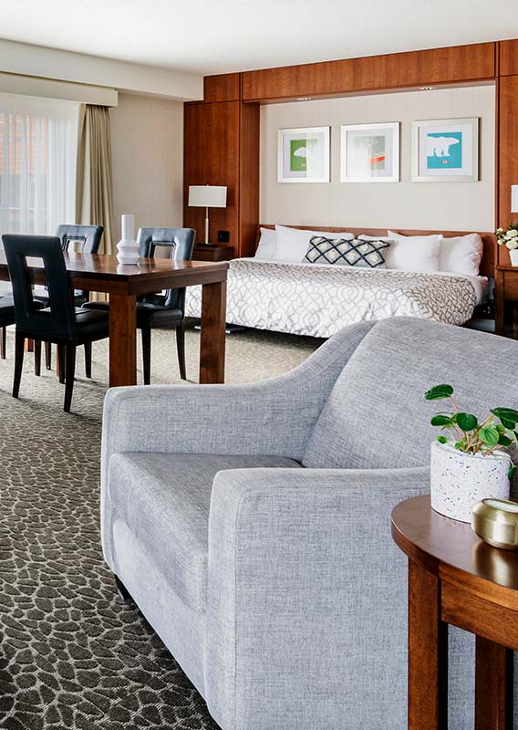 Grey chair and bed in a modern rustic hotel