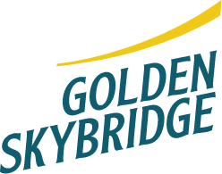 A narrow suspension footbridge stretches across a canyon.