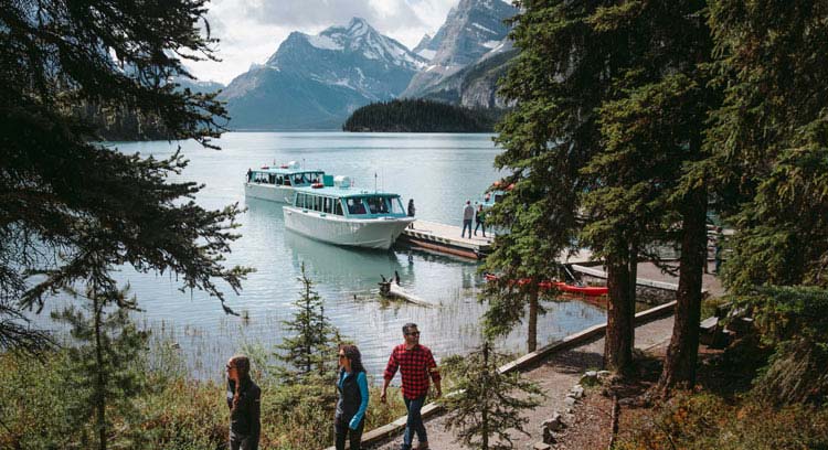 Boats on the Maligne Lake with mountains in the background