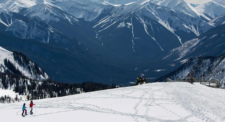 Couple snowshoeing in the mountains