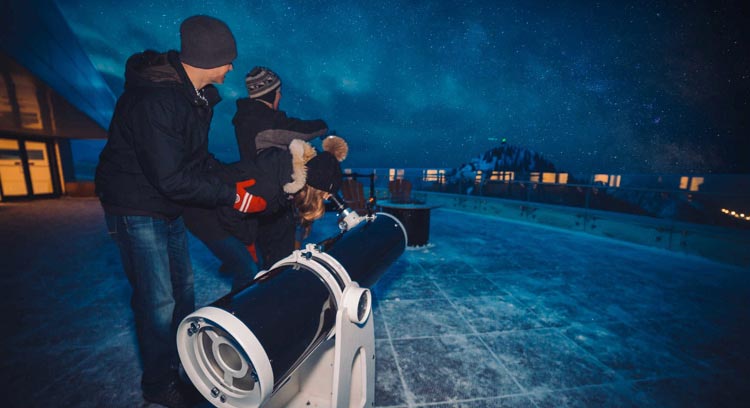 Participants viewing the stars through a microscope