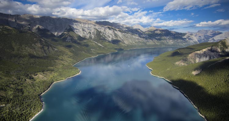 A bird's eye view of a large blue lake surrounded by mountains.