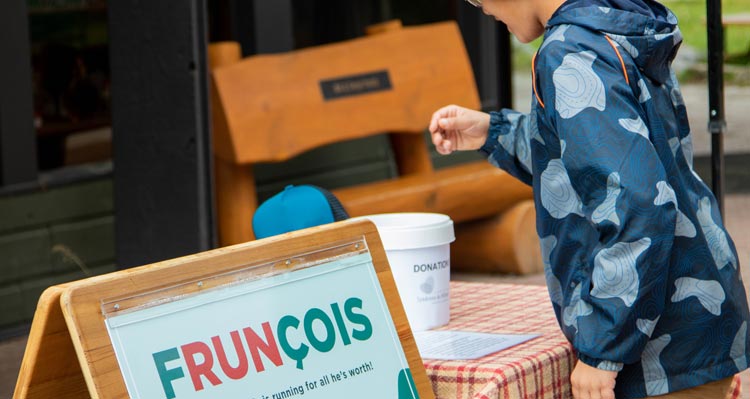 A child puts a donation into a donation bin.