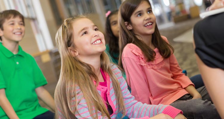 Children sitting and smiling