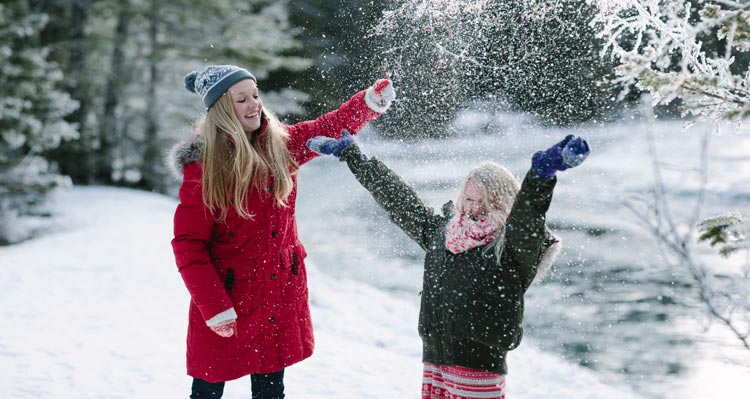 Two children play with powdery snow