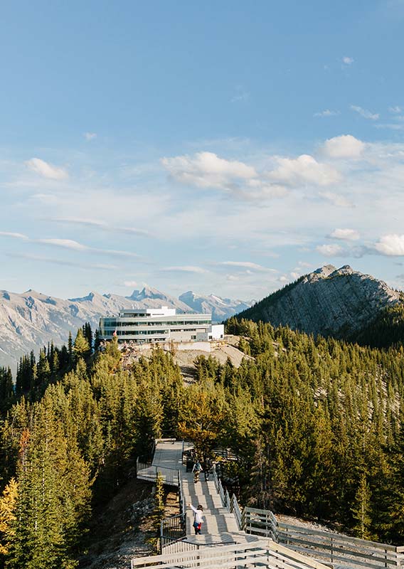 The Banff Gondola summit building atop Sulphur Mountain overlooking forested mountainsides