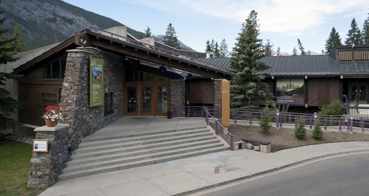 A mid-century modern building with stone walls