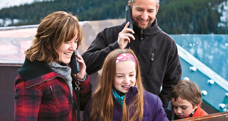 A family listens to audioguides on the Columbia Icefield Skywalk.