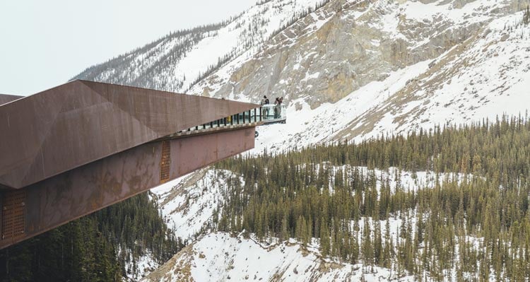 The Glacier Skywalk juts out from a cliffside over a deep, wide valley.