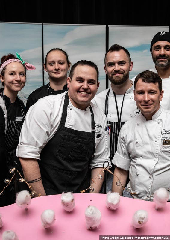 Chef Scott Hergott and the Sky Bistro culinary team in front of their dessert creation