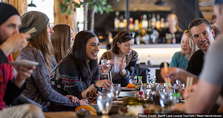 A group of people sit around a table for drinks.