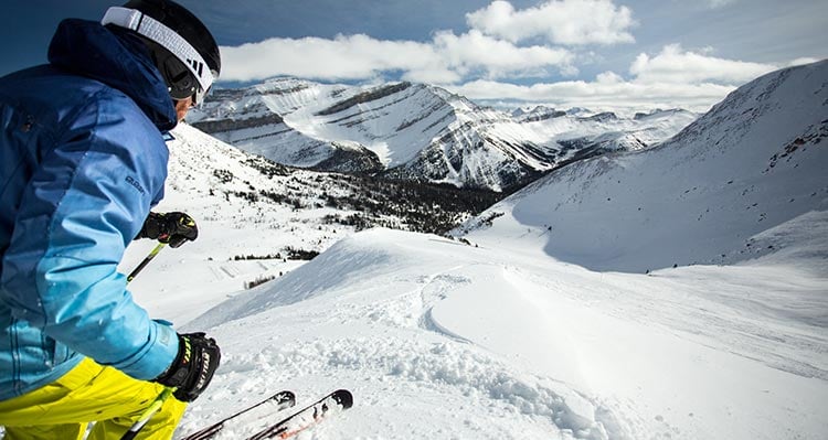 A skiier gets ready for a steep run.