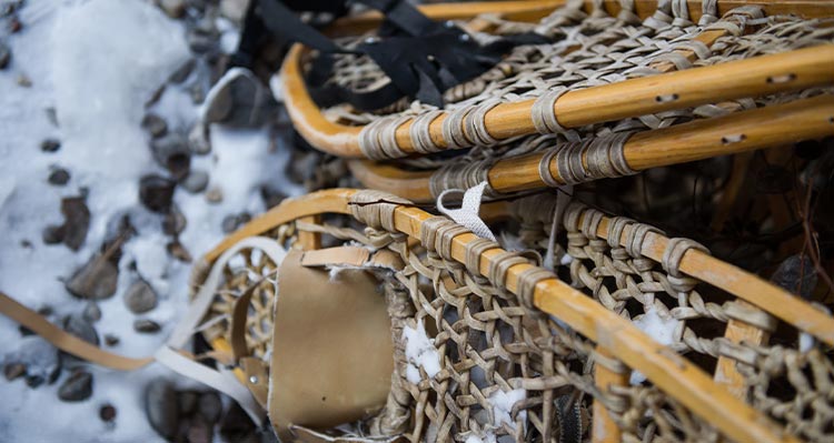 Pairs of showshoes on the snow.