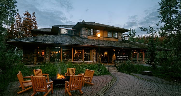 The Maligne Canyon Wilderness Kitchen at dusk with a campfire out front