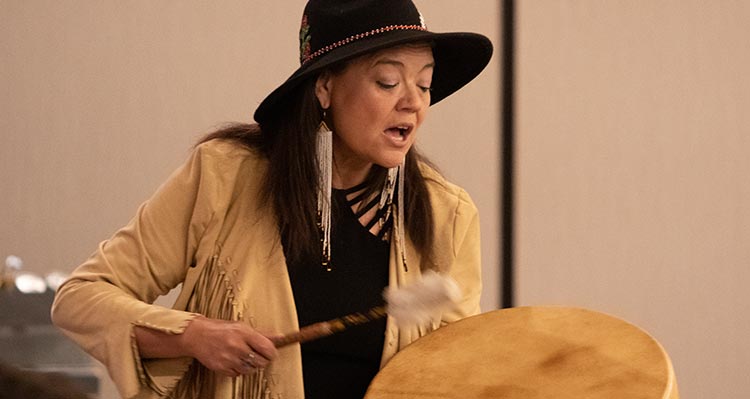 Matricia Brown plays a drum.