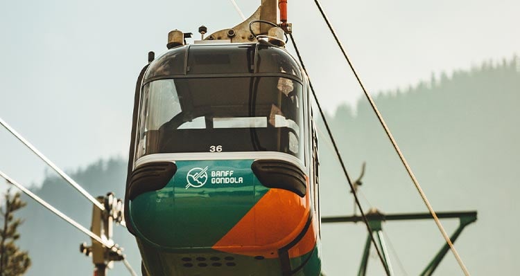 An orange and teal gondola cabin.