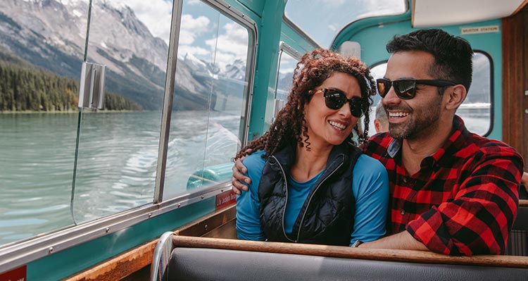 Two people look out from a boat.