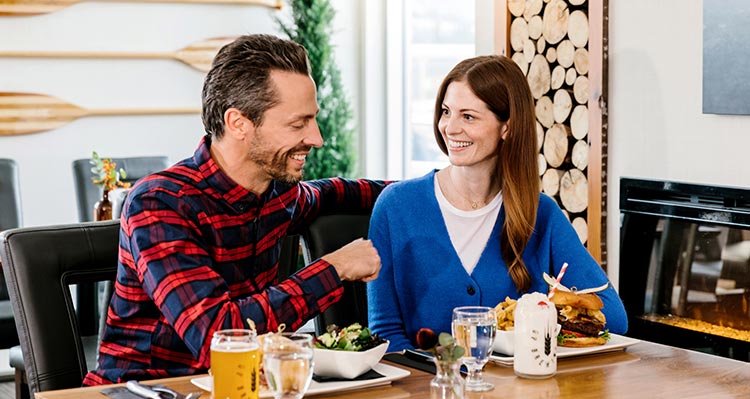 Two people sit for dinner.