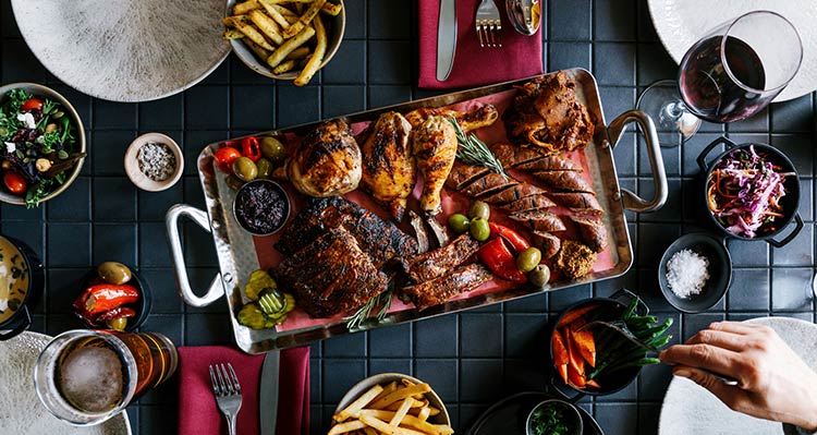 A platter of smoked meats and side dishes.