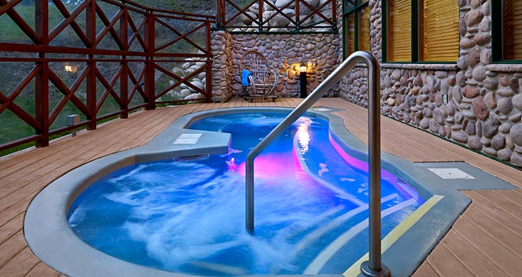 A hot tub glows blue and purple.