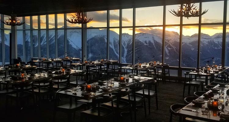 A dining room view overlooking a mountain range.