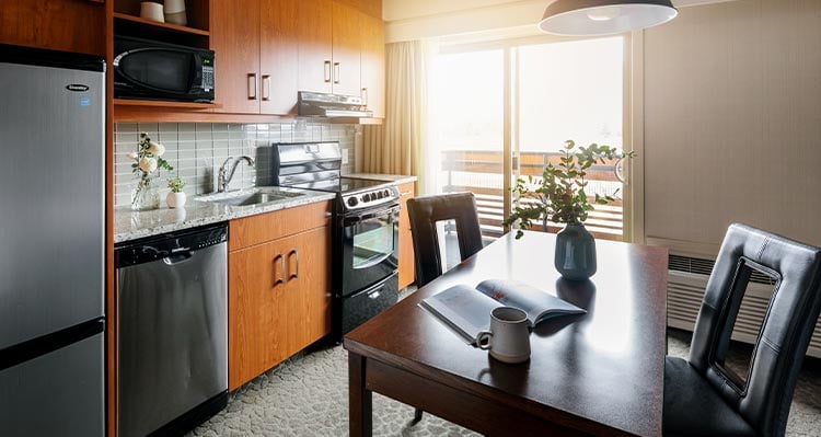 A hotel room kitchen and dining table.