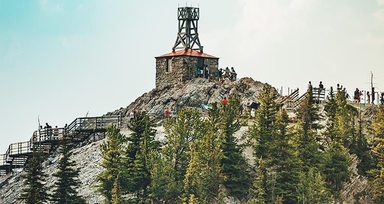 Groups of hikers walk along the top of the gondola board walk