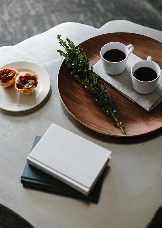 A tray of coffee and breakfast set up on a table.