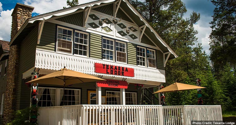 An older building style with a patio surrounded by a white fence.