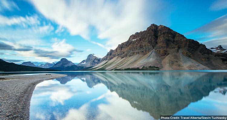 A mountain reflects in the calm lake.