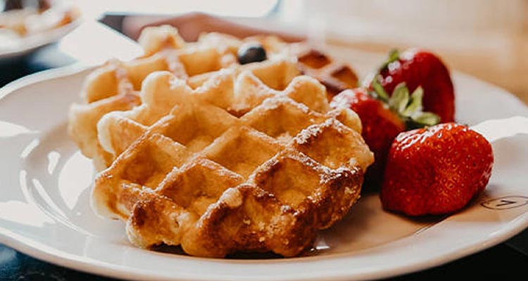 Waffles on a plate with berries.
